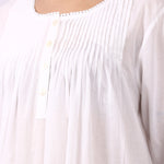 Close-up of pintuck bodice and rounded neckline on Lotus Sara white cotton nightdress.