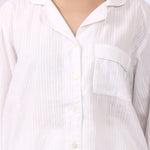 Close-up of revere collar cotton pyjama shirt with self-stripe and chest pocket.