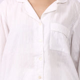 Close-up of revere collar cotton pyjama shirt with self-stripe and chest pocket.