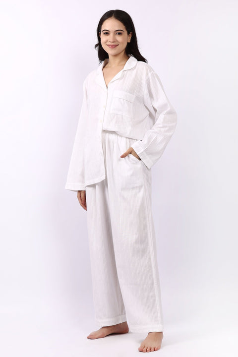 Side profile of Lotus Jacqui long cotton pyjama set in white self-stripe with side pocket detail.