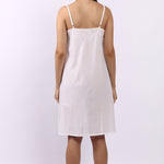 Back view of Lotus white cotton slip with adjustable straps, breathable woven cotton.