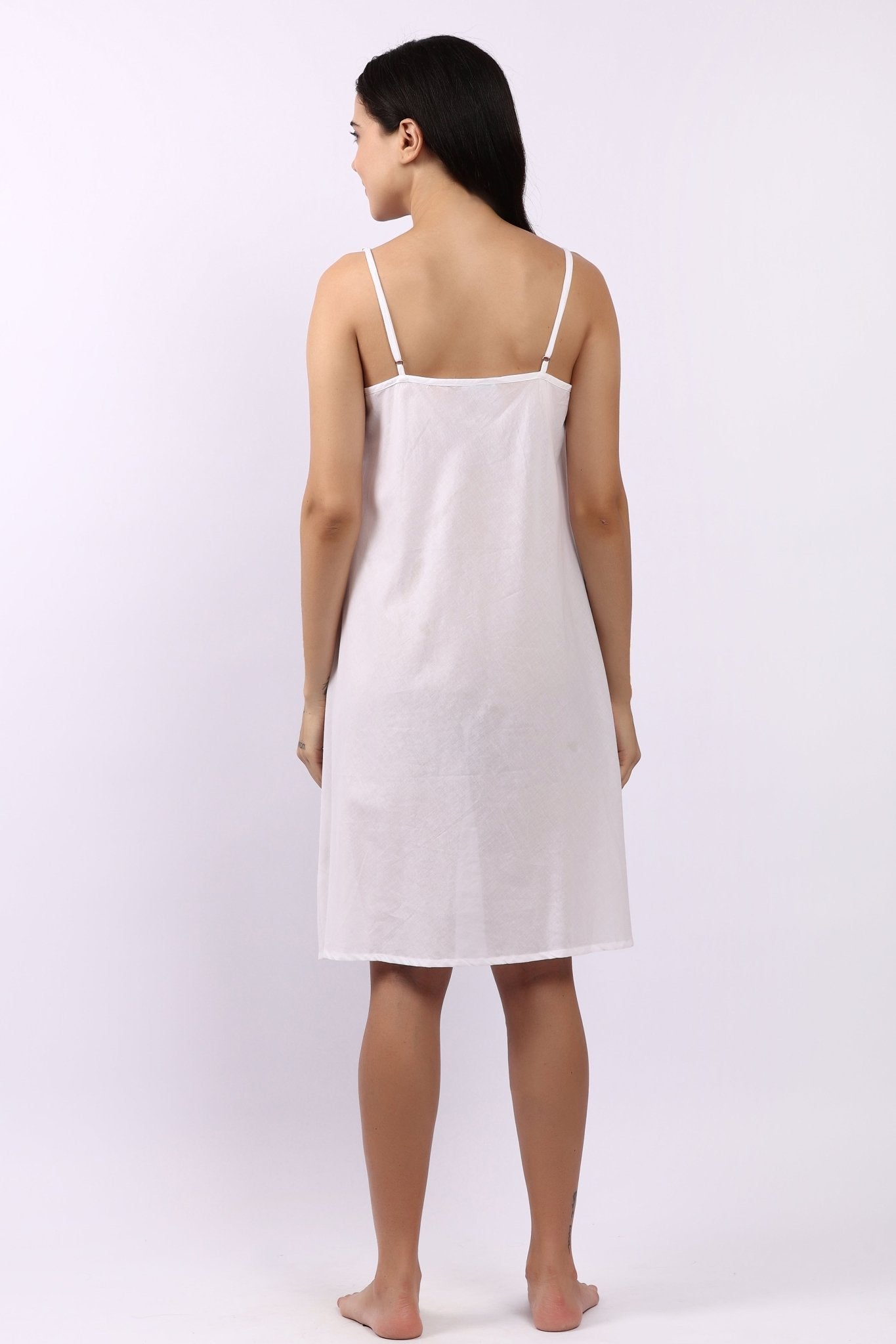 Back view of Lotus white cotton slip with adjustable straps, breathable woven cotton.