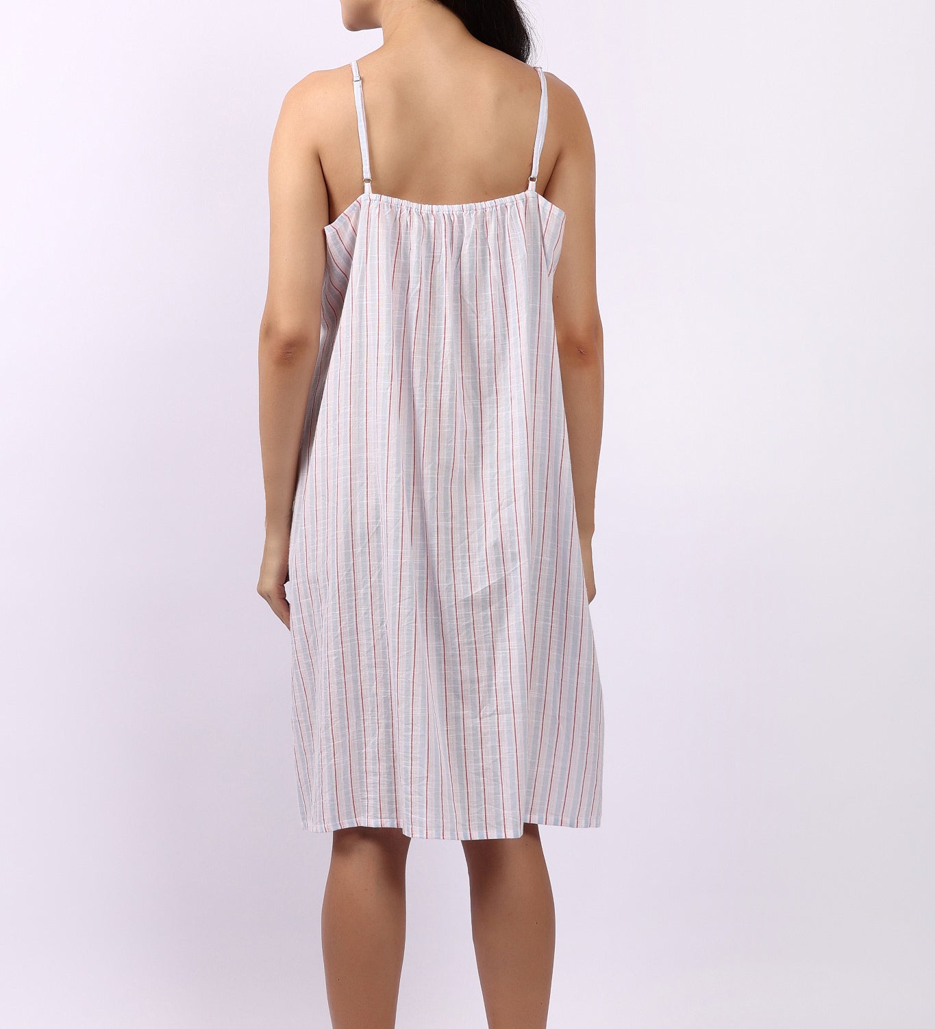 Woman wearing Lotus Frilly Nightie Sky Stripe, sleeveless cotton nightdress with frill detail back view