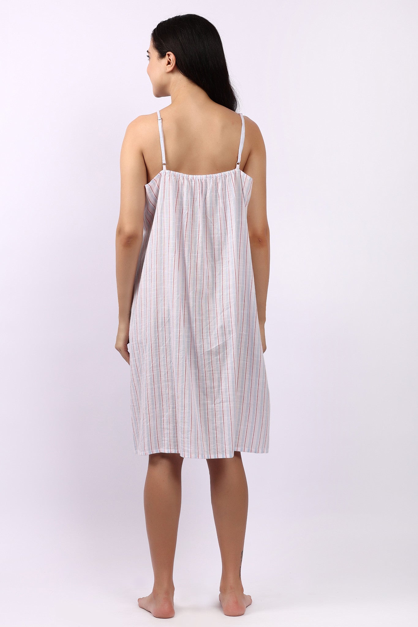 Woman wearing Lotus Frilly Nightie Sky Stripe, sleeveless cotton nightdress with frill detail back view