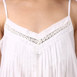Close-up of lace-trim V-neckline with pintuck detailing on Lotus Susie spaghetti strap cotton nightdress.