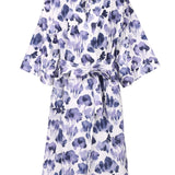 Floral patterned dress with a belt on a white background