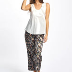 Model wearing ivory Mono Silk Cami paired with printed pants, featuring wide straps and a scoop neckline.