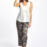 Model wearing ivory Mono Silk Cami paired with printed pants, featuring wide straps and a scoop neckline.