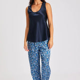 Model wearing navy Mono Silk Cami with printed blue pants, featuring a scoop neckline and wide straps.