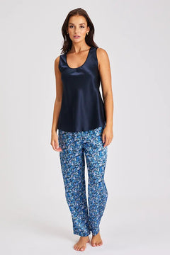 Model wearing navy Mono Silk Cami with printed blue pants, featuring a scoop neckline and wide straps.