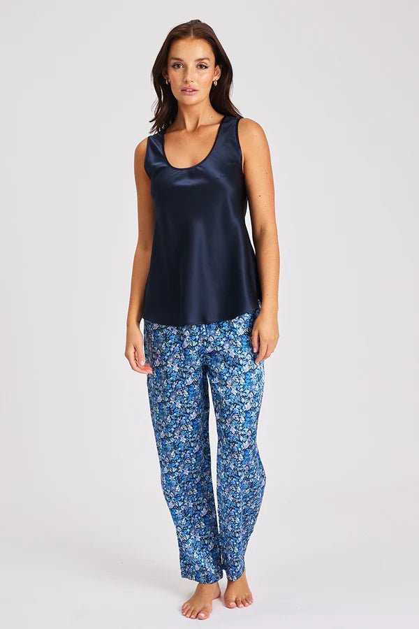 Model wearing navy Mono Silk Cami with printed blue pants, featuring a scoop neckline and wide straps.