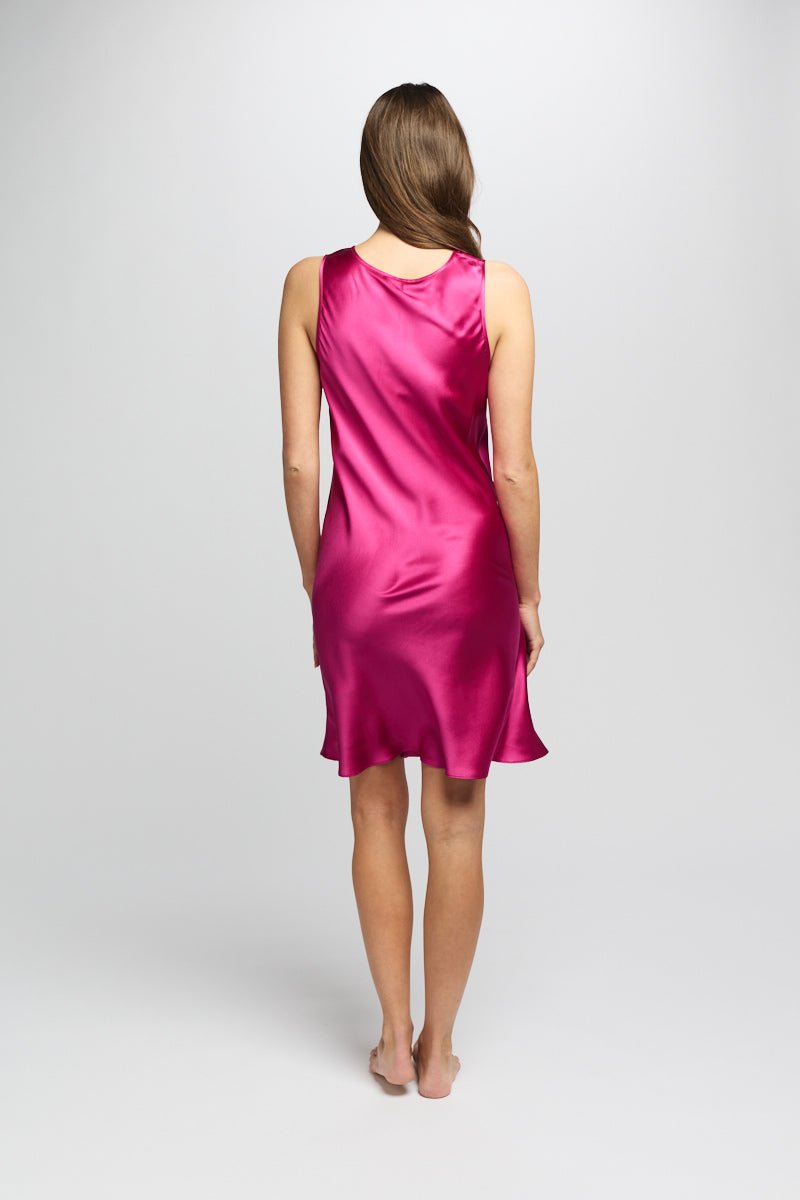 Back view of Model in cerise silk nightie showing a soft A-line silhouette with luxurious sheen and bias-cut shape.