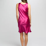 Back view of Model in cerise silk nightie showing a soft A-line silhouette with luxurious sheen and bias-cut shape.