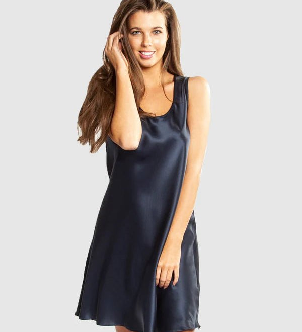 Model wearing Mono Silk Short Nightie in navy, featuring a flattering low neckline, wide straps, and a draped silk finish just above the knee.