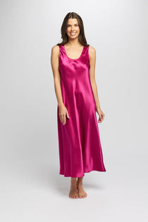 Model wearing cerise silk long nightie with scoop neck and wide straps, cut on the bias for an elegant drape.