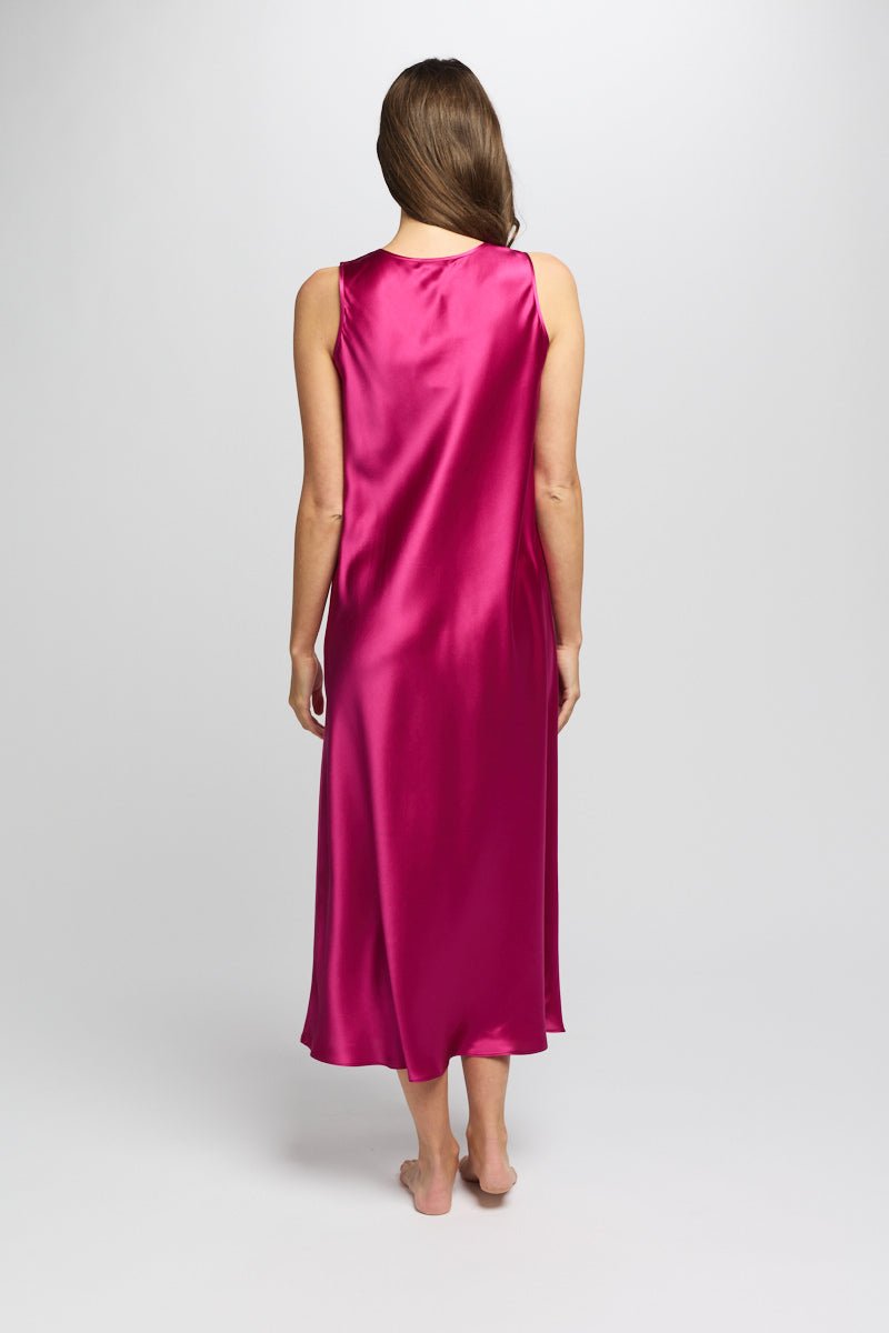 Back of cerise silk nightie flowing softly as model walks, showing smooth, seamless design.
