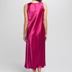 Back of cerise silk nightie flowing softly as model walks, showing smooth, seamless design.