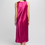 Back of cerise silk nightie flowing softly as model walks, showing smooth, seamless design.