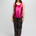 Model wearing bright cerise Mono Silk Cami paired with floral pants, featuring a scoop neckline and wide shoulder straps.