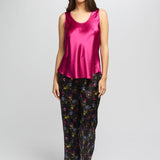 Model wearing bright cerise Mono Silk Cami paired with floral pants, featuring a scoop neckline and wide shoulder straps.