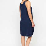 Back view of the Louisa Swing Nightdress, highlighting the relaxed fit, pleating, and shaped hem.