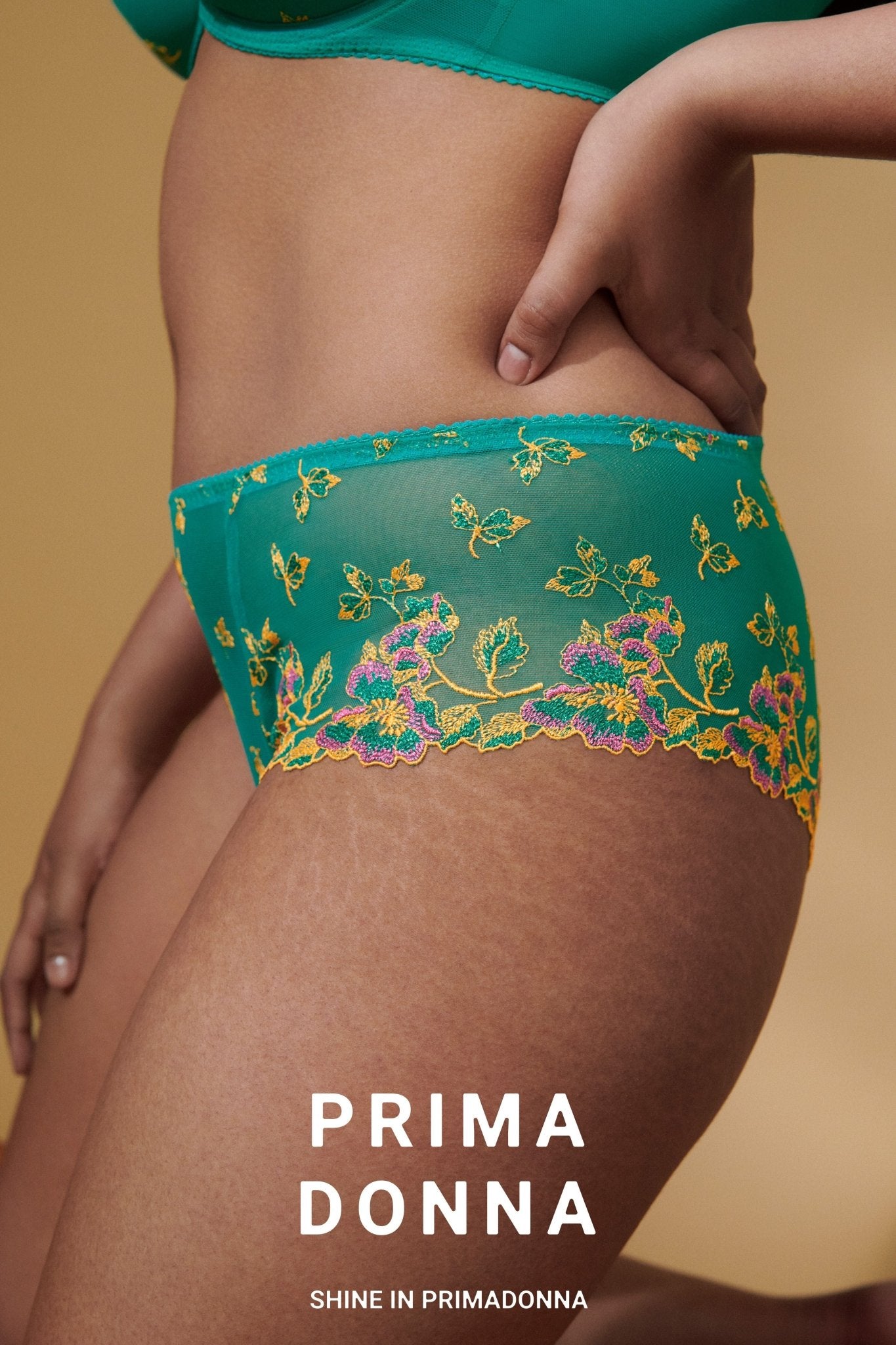 Side angle of Lenca Luxury Thong Sunny Teal from The Foundation, highlighting lace detail and luxurious fit