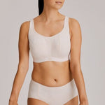 Full-body view of model wearing the Gym Sports Bra in Venus with activewear styling.