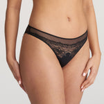 Side angle of model in Junoo Rio Brief Black from The Foundation, highlighting the modern high-cut leg and timeless design