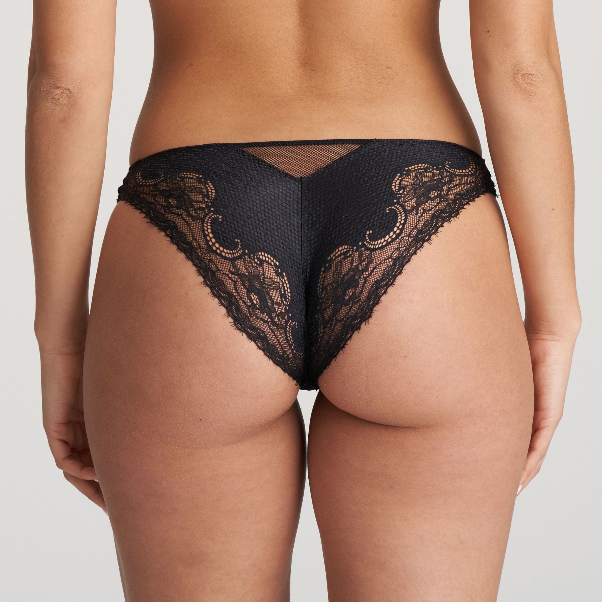 Model wearing Junoo Rio Brief Black from The Foundation, showing full coverage at the back and a confident, stylish fit