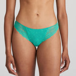 Model wearing Marie Jo Melipha Rio Brief in Vivid Green, featuring high-cut legs and soft lace for a seamless fit.