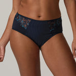 Model wearing PrimaDonna Deauville Full Briefs Velvet Blue, showcasing elegant high waist fit and blue embroidery detail from The Foundation.