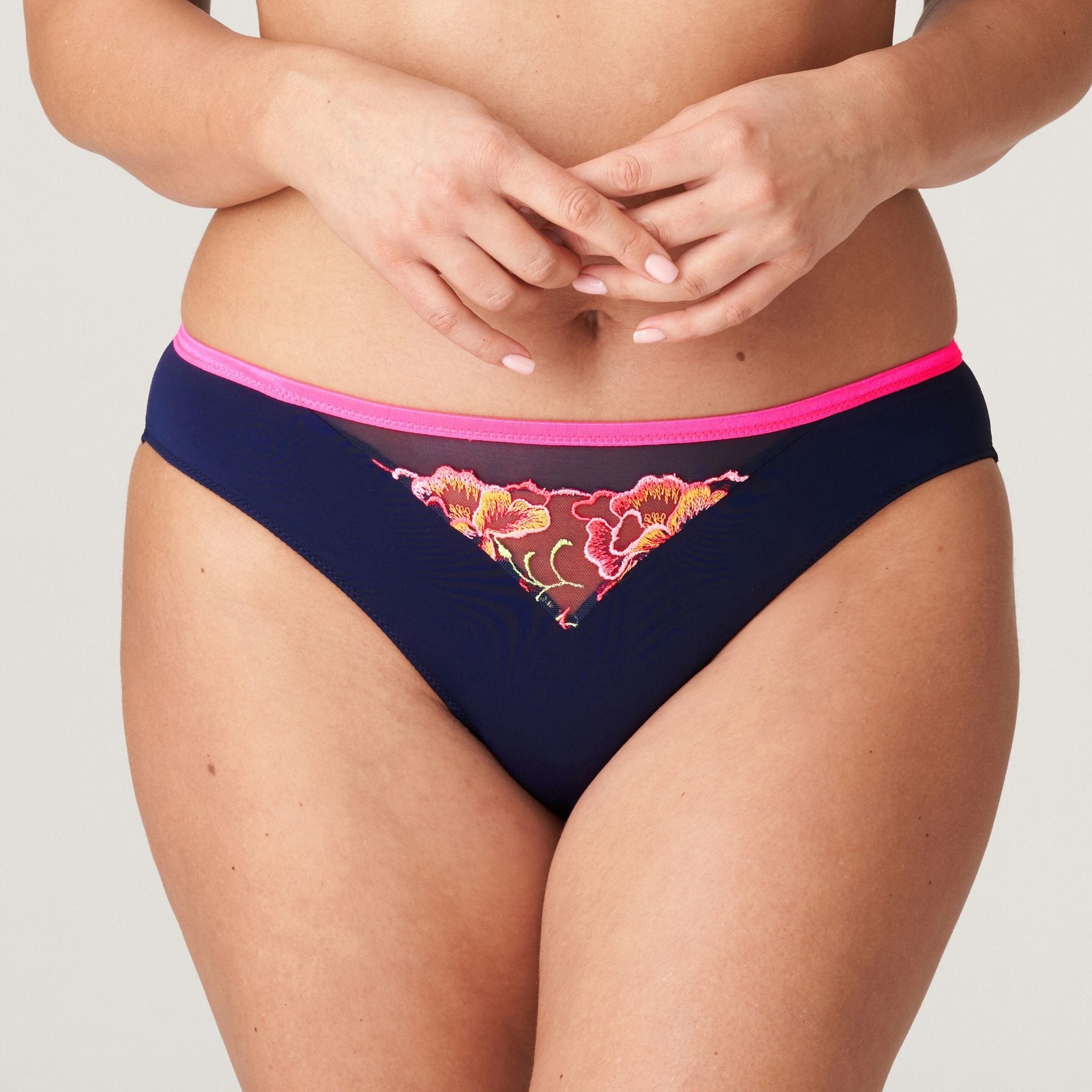 Front view of Devdaha Rio Brief Velvet Blue from The Foundation, featuring neon pink floral embroidery on dark blue opaque fabric