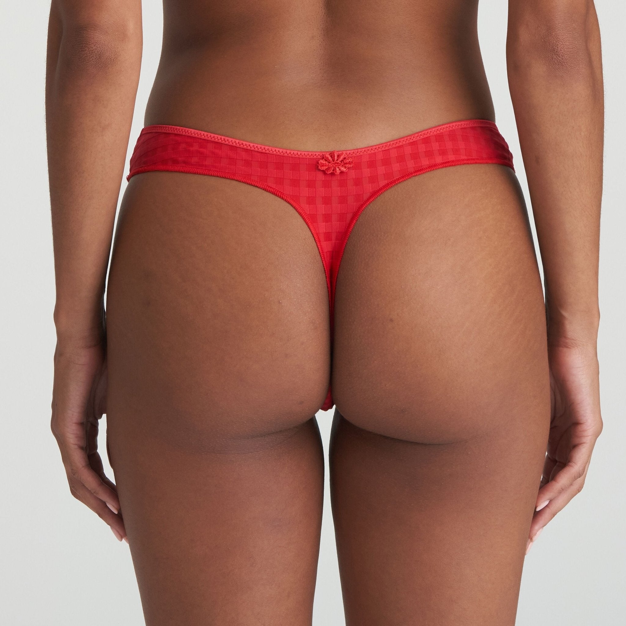 Back view of model in Marie Jo Avero Thong Brief Scarlet highlighting G-string cut and flattering fit.