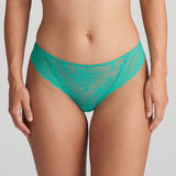 Model wearing the Melipha Thong in Vivid Green, showcasing flattering high-leg fit and soft lace finish.