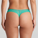 Back view of Model showing back of the Melipha Thong, featuring sheer lace and minimal coverage for a seamless look.