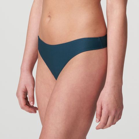 Side angle of Tom Mini Thong Brief Emerald Green, highlighting the sleek fit and signature small circle at the hip