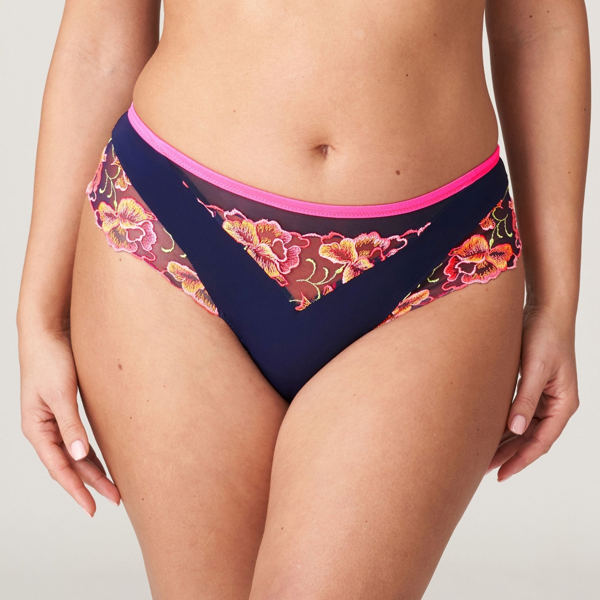 Devdaha Luxury Thong Brief by PrimaDonna – close-up of floral embroidery and neon pink waistband on velvet blue mesh.