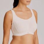 Model wearing Venus Gym Sports Bra – soft neutral colour with wide shoulder straps and contoured cups. Side angle