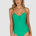 Woman wearing a green swimsuit on a gray background