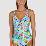 Woman wearing a colorful floral swimsuit on a white background