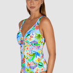 Woman wearing a colorful floral swimsuit on a white background