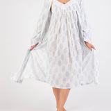 Model wearing Cotton Robe in white with blue paisley print, featuring a tie waist and airy cotton voile for breathable comfort.