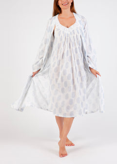 Model wearing Cotton Robe in white with blue paisley print, featuring a tie waist and airy cotton voile for breathable comfort.