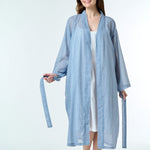 Model wearing Hand Loomed Cotton Robe in navy gingham, featuring lightweight cotton voile and waist tie for airy summer layering.
