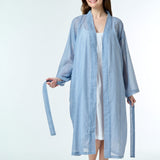 Model wearing Hand Loomed Cotton Robe in navy gingham, featuring lightweight cotton voile and waist tie for airy summer layering.
