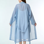 navy gingham cotton robe, shown tied at the waist, highlighting the soft drape and hand-loomed fabric texture.