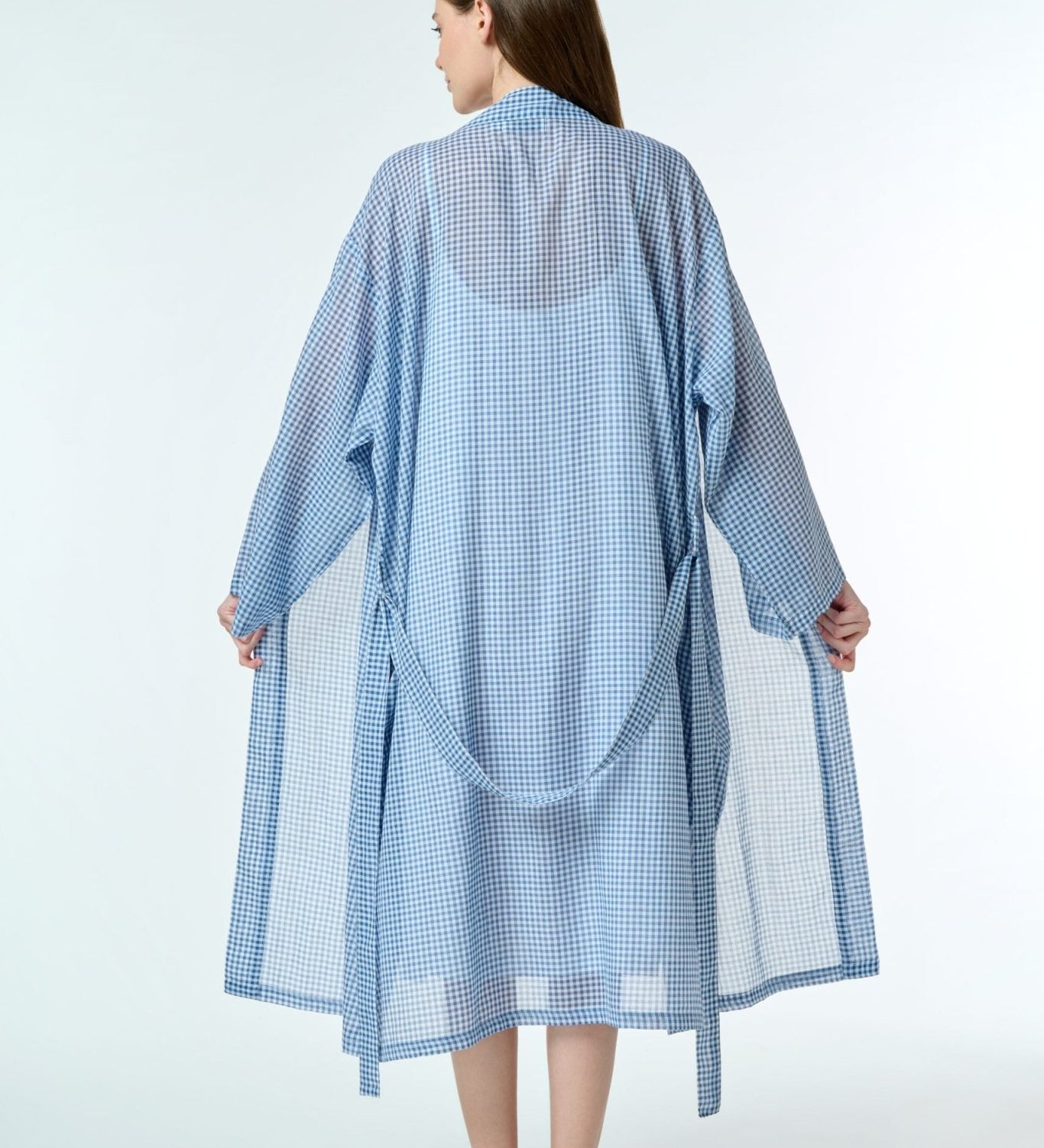 navy gingham cotton robe, shown tied at the waist, highlighting the soft drape and hand-loomed fabric texture.