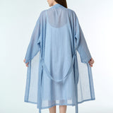 navy gingham cotton robe, shown tied at the waist, highlighting the soft drape and hand-loomed fabric texture.