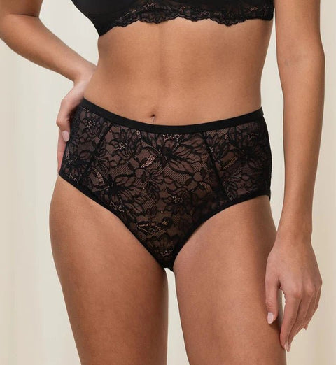 Model in full standing pose wearing Triumph shaping brief with high-cut leg and ribbed waistband.