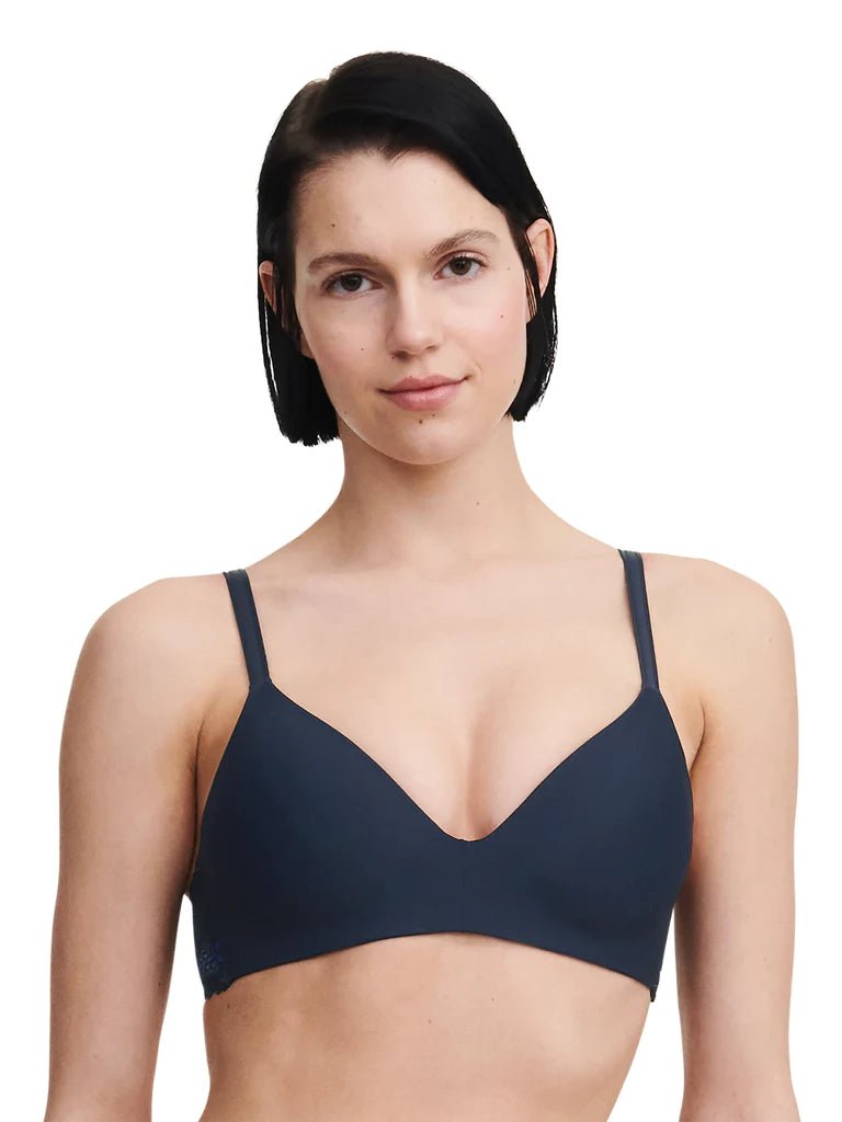 Model wearing the Passionata Pila Wirefree T-Shirt Bra in Sailing Blue with a plunging neckline and smooth, molded cups for a seamless everyday fit.